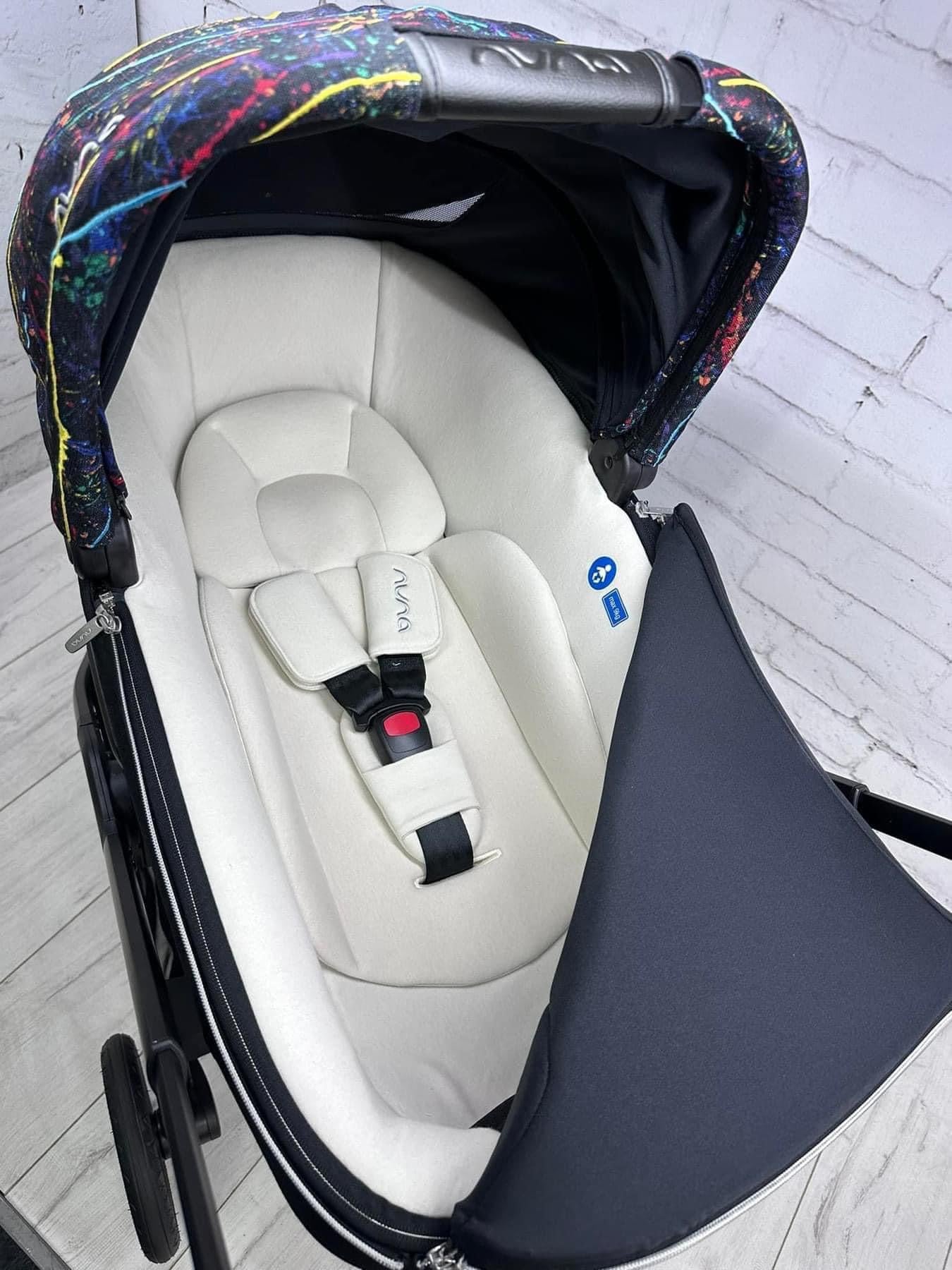 Nuna Triv Next and Cari Carrycot Rainbow Georgette Polizzi Todl and rotating base