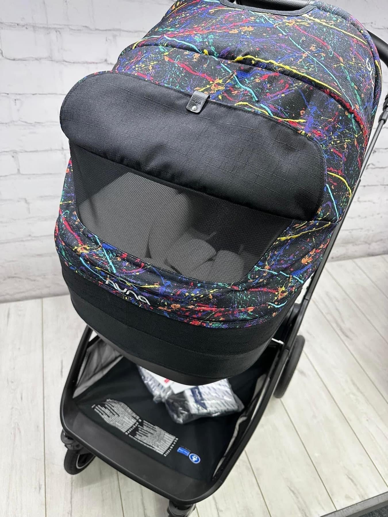 Nuna Triv Next and Cari Carrycot Rainbow Georgette Polizzi Todl and rotating base